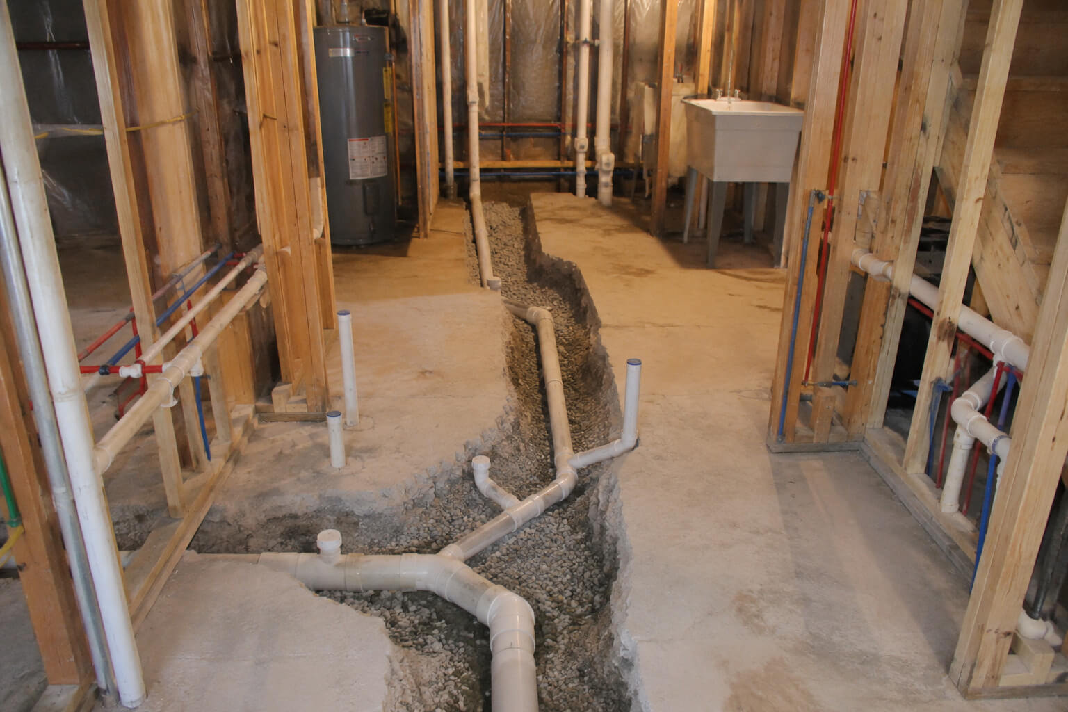 Tankless water heater unit installed in a finished basement mechanical room